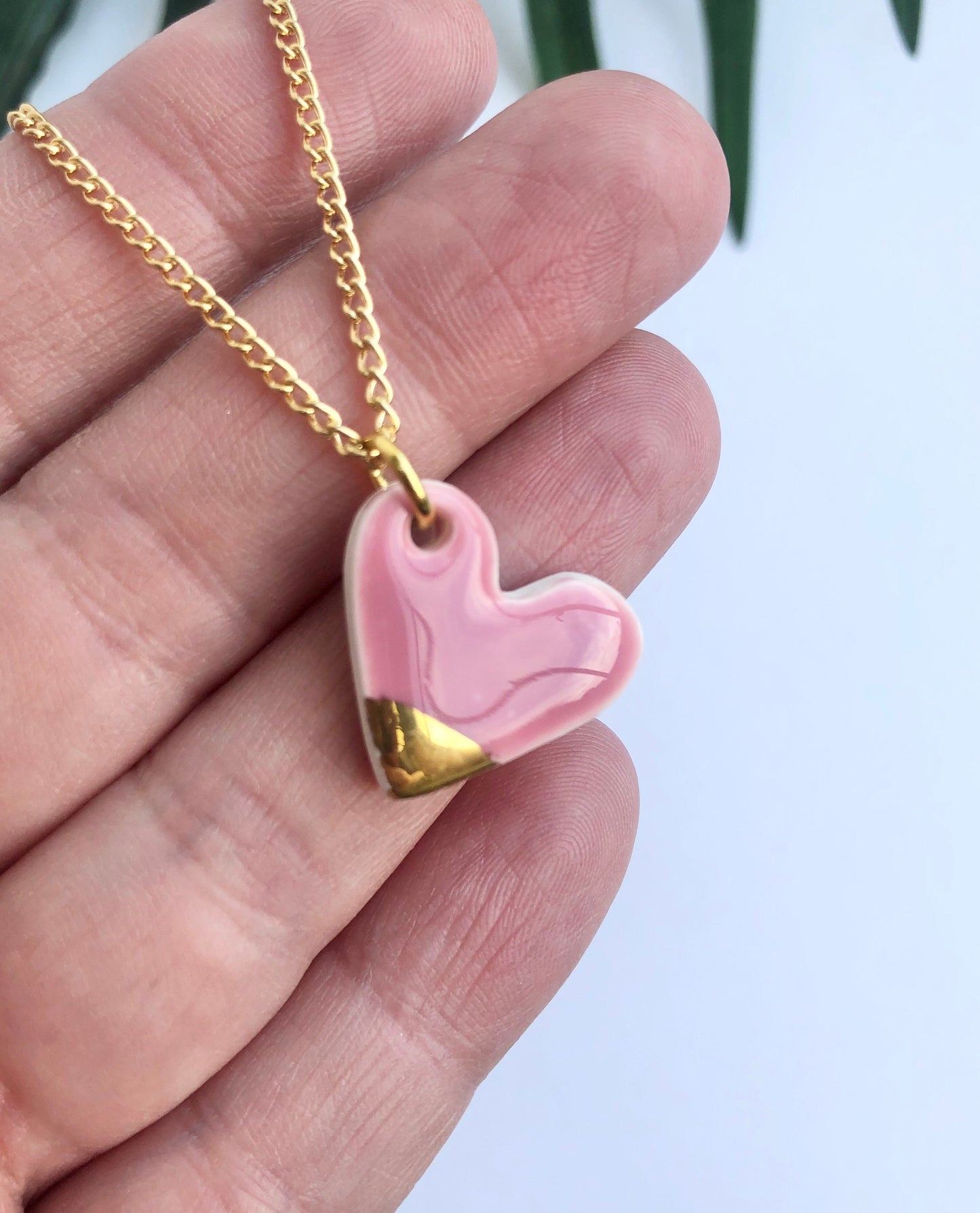 Pink small heart necklace with a gold tip