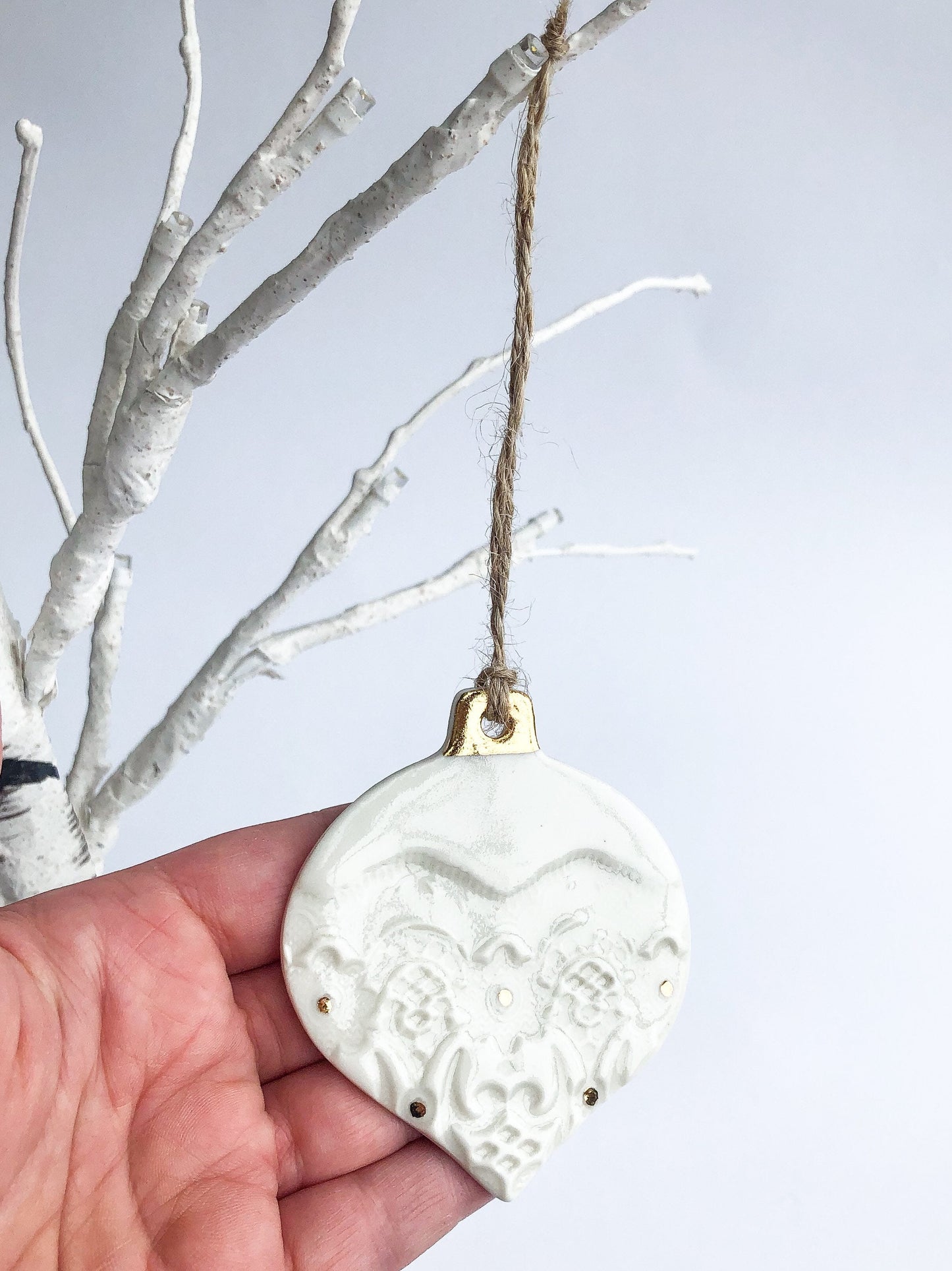 White bauble with gold detail and dots ornament