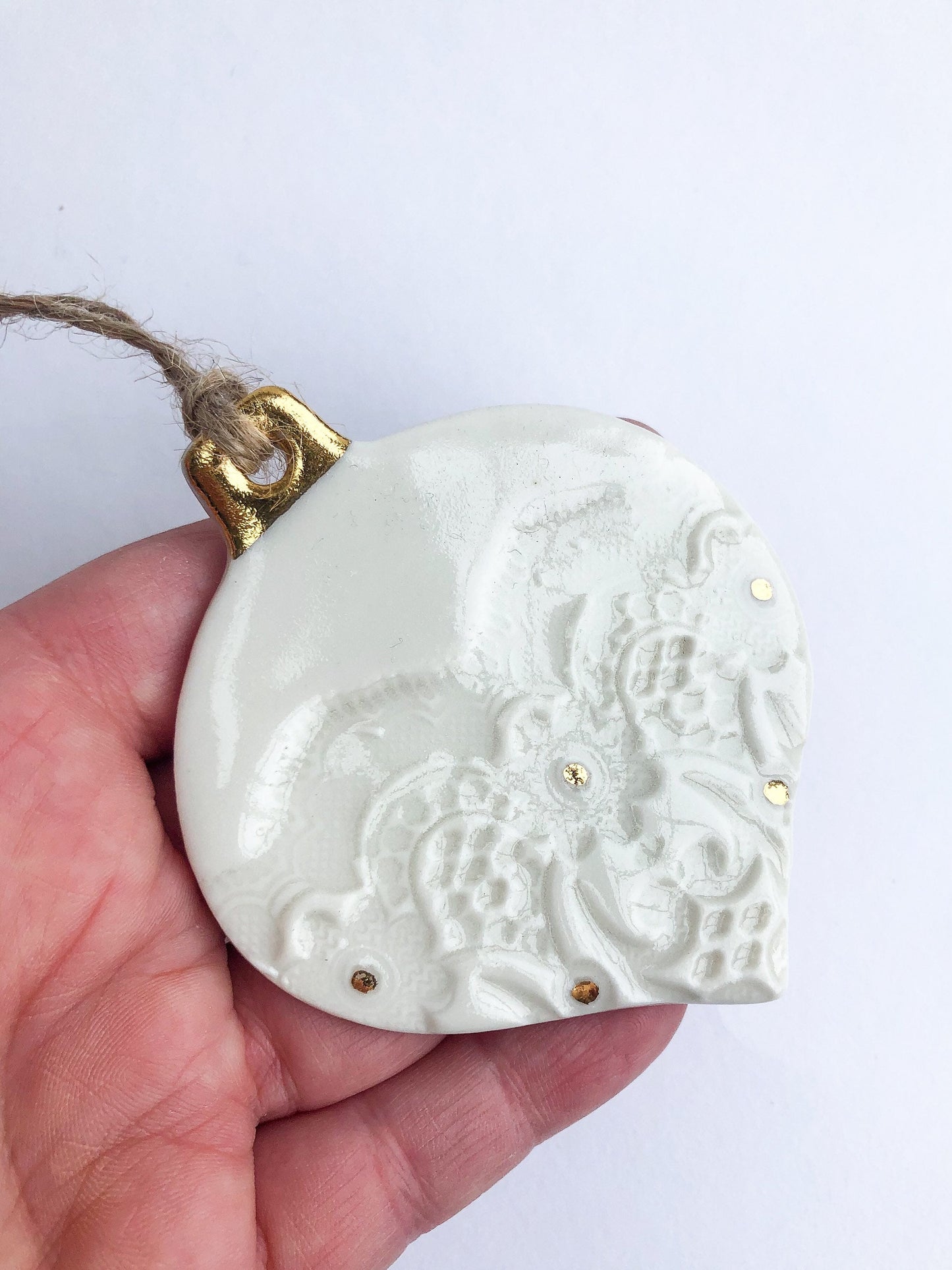 White bauble with gold detail and dots ornament