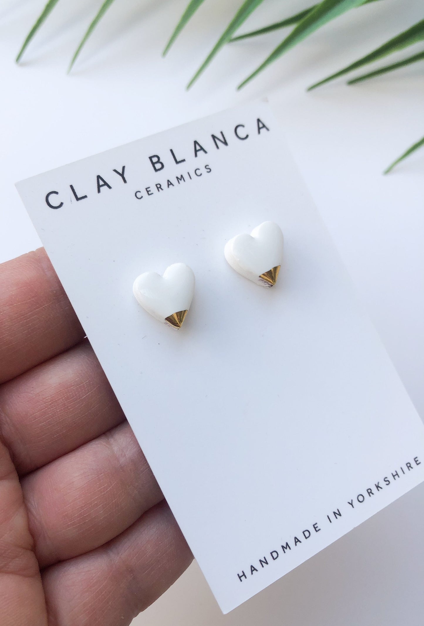 White heart studs with gold tips