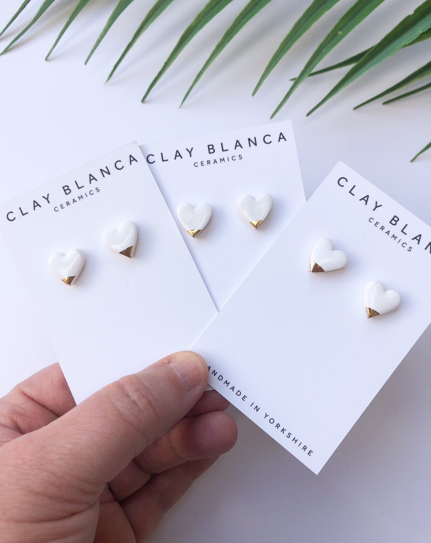 White heart studs with gold tips