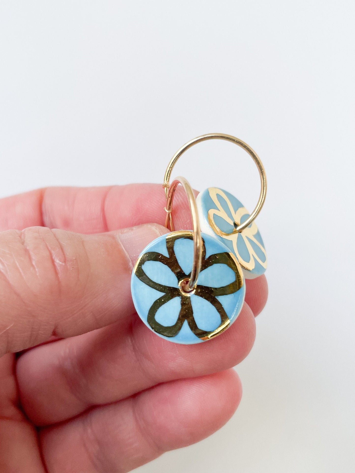 Blue with gold flower design on large hoops