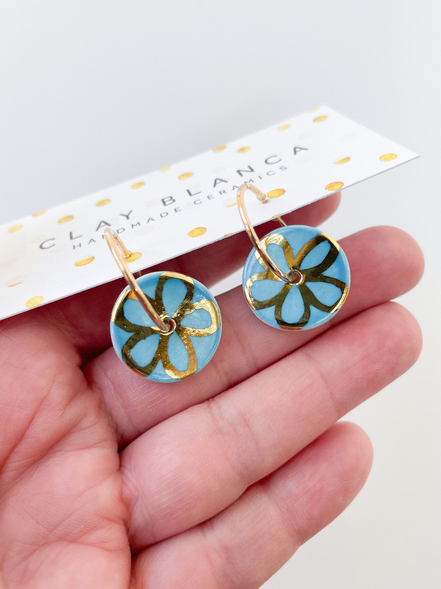 Blue with gold flower design on large hoops