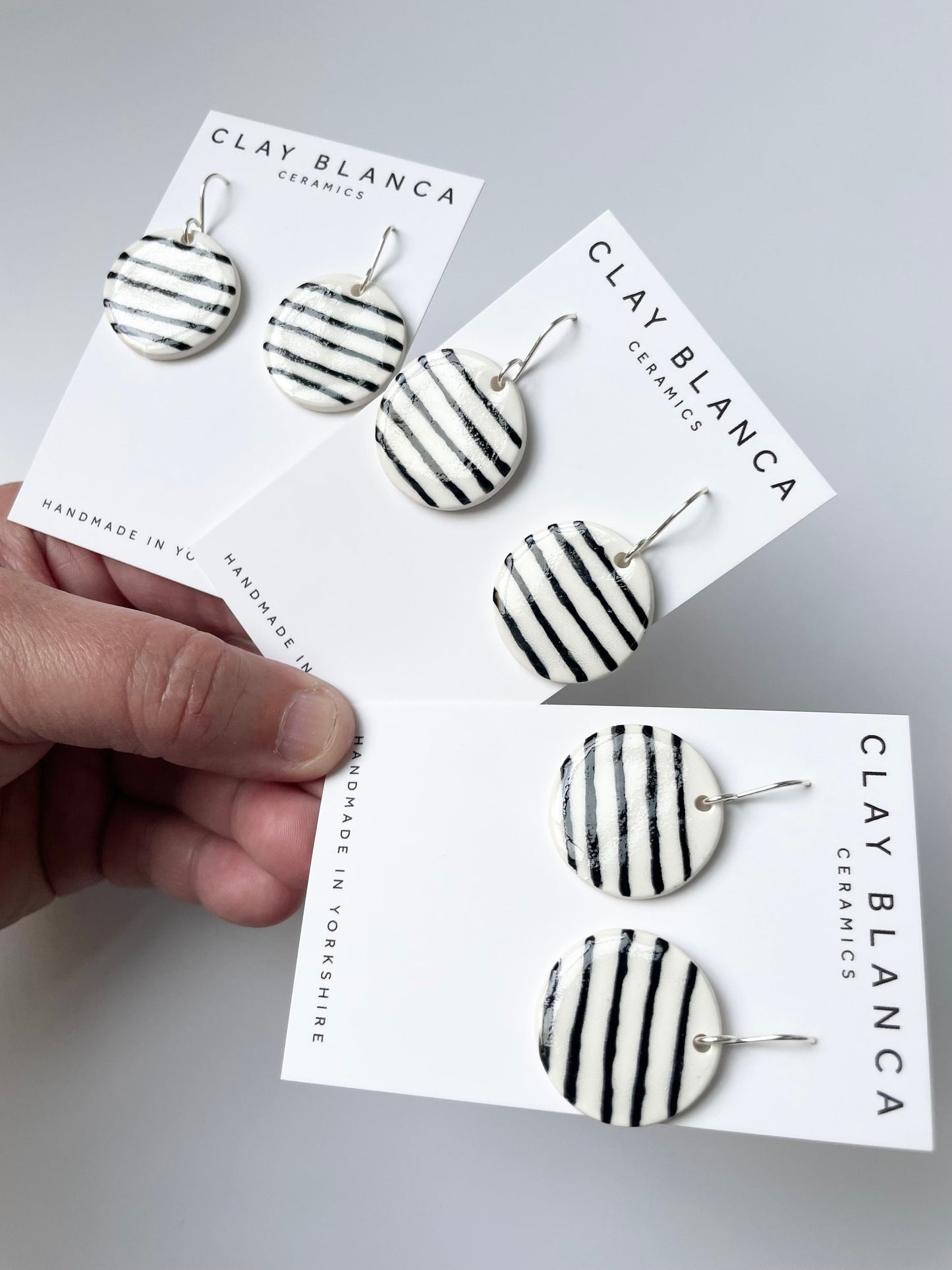 Round White earrings with black stripes