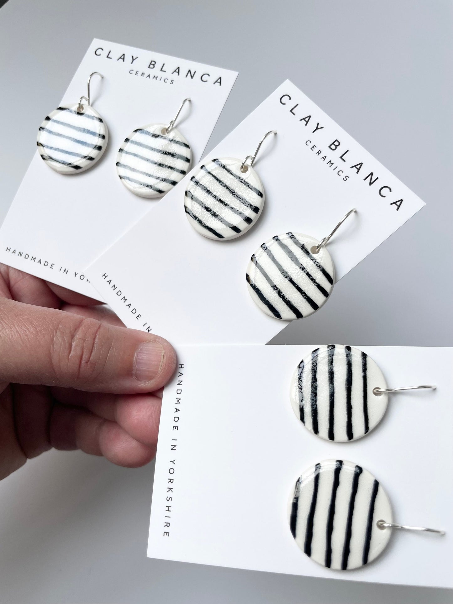 Round White earrings with black stripes