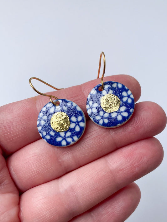 Blue earrings with small white flower design